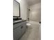 Modern bathroom with gray vanity, black fixtures, and a tiled shower-tub combination at 149 Silvercrest Dr, Acworth, GA 30101