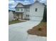 Charming two-story home with white siding, a black roof, and an attached two-car garage at 149 Silvercrest Dr, Acworth, GA 30101