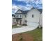 Charming two-story home with white siding, a black roof, and an attached two-car garage at 149 Silvercrest Dr, Acworth, GA 30101