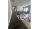 Hallway featuring dark hardwood floors, wood railing, and natural light from windows at 149 Silvercrest Dr, Acworth, GA 30101