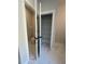 Hallway view leading to a toilet room and walk-in closet with modern black hardware and marble-look tile flooring at 149 Silvercrest Dr, Acworth, GA 30101