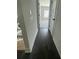 Hallway featuring dark hardwood floors, wood railing, and natural light from windows at 149 Silvercrest Dr, Acworth, GA 30101