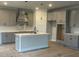 Modern kitchen features an island with sink and neutral cabinets at 149 Silvercrest Dr, Acworth, GA 30101