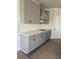 Kitchenette area with gray cabinetry, herringbone backsplash, and quartz countertops at 149 Silvercrest Dr, Acworth, GA 30101