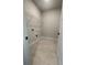 Bright laundry room with tile flooring, wire shelving, and washer/dryer hookups for convenience at 149 Silvercrest Dr, Acworth, GA 30101