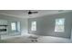 Large, open living room with windows, a ceiling fan, and a fireplace, all in light gray tones at 149 Silvercrest Dr, Acworth, GA 30101