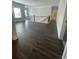 Bright living room featuring dark hardwood floors, a staircase, and large windows for natural light at 149 Silvercrest Dr, Acworth, GA 30101