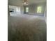 Spacious carpeted living room with three large windows, fireplace and ceiling fan at 149 Silvercrest Dr, Acworth, GA 30101