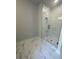 Modern bathroom shower featuring marble-look tile, a sleek glass enclosure, and contemporary fixtures at 149 Silvercrest Dr, Acworth, GA 30101