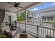 Relaxing back porch with comfortable seating, dining area, string lights, and neighborhood views at 214 Bluestone Dr, Woodstock, GA 30188