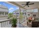 Cozy back porch features ceiling fan, outdoor seating, fire pit, and views of the neighborhood at 214 Bluestone Dr, Woodstock, GA 30188