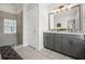 Modern bathroom featuring double vanity, glass shower with bench, and neutral color palette at 214 Bluestone Dr, Woodstock, GA 30188