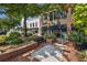 A charming commercial district featuring brick buildings, benches, and lush landscaping, creating a welcoming atmosphere for shoppers at 214 Bluestone Dr, Woodstock, GA 30188