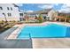 Beautiful community pool surrounded by well-manicured landscaping and modern townhomes, perfect for relaxation and social gatherings at 214 Bluestone Dr, Woodstock, GA 30188