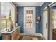 Stylish entryway with a decorative table, a door with glass and a view of the house exterior at 214 Bluestone Dr, Woodstock, GA 30188