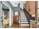 Elegant entryway features a staircase with hardwood floors and stylish decor at 214 Bluestone Dr, Woodstock, GA 30188