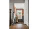Elegant hallway with wood floors, gray wainscoting, and stylish wall decor at 214 Bluestone Dr, Woodstock, GA 30188