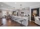 Modern kitchen boasts a large island with seating, stainless steel appliances, and stylish pendant lighting at 214 Bluestone Dr, Woodstock, GA 30188