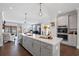 Open kitchen featuring stainless appliances, a large center island and light colored cabinets at 214 Bluestone Dr, Woodstock, GA 30188