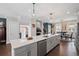 Spacious kitchen offers a large center island, stainless steel appliances and hardwood flooring at 214 Bluestone Dr, Woodstock, GA 30188