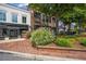 Attractive street view showcasing a well-maintained sidewalk, brick planters, and thriving businesses at 214 Bluestone Dr, Woodstock, GA 30188