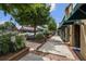 Charming street view with mature trees, brick-lined sidewalks, and storefronts with awnings, creating a vibrant atmosphere at 214 Bluestone Dr, Woodstock, GA 30188