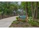 Scenic trail entrance with lush greenery, wooden signage, and a welcoming path for outdoor adventures at 214 Bluestone Dr, Woodstock, GA 30188