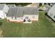 Aerial view of the backyard with a patio and spacious green lawn at 3984 Potomac Walk Ct, Loganville, GA 30052