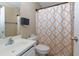 Well-lit bathroom with a patterned shower curtain and white fixtures at 3984 Potomac Walk Ct, Loganville, GA 30052
