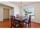 A formal dining room with a classic table set, bathed in natural light from a large window at 3984 Potomac Walk Ct, Loganville, GA 30052