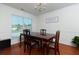 Dining area featuring hardwood floors, classic table and chairs, and ample natural light at 3984 Potomac Walk Ct, Loganville, GA 30052