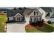 View of a house with a spacious driveway and well-kept lawn, showcasing suburban living at 3984 Potomac Walk Ct, Loganville, GA 30052