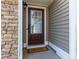 Inviting front entrance with a stone accent wall and a warm 'Welcome' mat at 3984 Potomac Walk Ct, Loganville, GA 30052