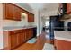Well-lit kitchen with wood cabinets, countertops, black appliances, and hardwood floors at 3984 Potomac Walk Ct, Loganville, GA 30052