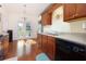Contemporary kitchen with wood cabinets, stainless steel sink and black appliances at 3984 Potomac Walk Ct, Loganville, GA 30052