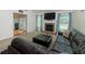 Inviting living room features a stone fireplace, TV, and comfortable leather sectional at 3984 Potomac Walk Ct, Loganville, GA 30052