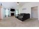 Spacious living room with a cozy fireplace, plush carpet, and comfortable leather furniture at 3984 Potomac Walk Ct, Loganville, GA 30052