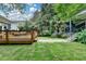 Serene backyard with a wooden deck, lush lawn, and mature trees perfect for outdoor relaxation at 799 Monroe Ne Dr, Atlanta, GA 30308