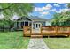 Backyard view showing a house, a deck and green yard, stone walkway at 799 Monroe Ne Dr, Atlanta, GA 30308