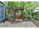 Charming backyard area with a wooden swing, landscaped garden, and lots of shade at 799 Monroe Ne Dr, Atlanta, GA 30308