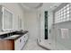 Modern bathroom features a double sink vanity, glass shower, and white subway tile at 799 Monroe Ne Dr, Atlanta, GA 30308
