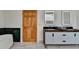 Bathroom featuring wood door, large vanity with double sinks, and black and green tiling at 799 Monroe Ne Dr, Atlanta, GA 30308