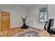Bright bedroom featuring hardwood floors, a wooden door, and an oriental rug at 799 Monroe Ne Dr, Atlanta, GA 30308