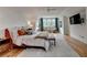 Bright bedroom with a ceiling fan, a sitting area by the window, and hardwood floors at 799 Monroe Ne Dr, Atlanta, GA 30308