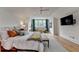 Bright bedroom with a ceiling fan, a sitting area by the window, and hardwood floors at 799 Monroe Ne Dr, Atlanta, GA 30308
