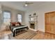 Cozy bedroom with hardwood floors, fireplace, and ample natural light at 799 Monroe Ne Dr, Atlanta, GA 30308