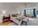 Bright bedroom with a ceiling fan, a sitting area by the window, and hardwood floors at 799 Monroe Ne Dr, Atlanta, GA 30308
