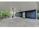 Spacious carport with a white ceiling, blue siding, and view of the manicured backyard at 799 Monroe Ne Dr, Atlanta, GA 30308