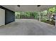 Large carport with view of landscaped backyard featuring a black metal fence and lots of greenery at 799 Monroe Ne Dr, Atlanta, GA 30308