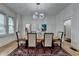 Elegant dining room with a modern chandelier, hardwood floors and large windows at 799 Monroe Ne Dr, Atlanta, GA 30308